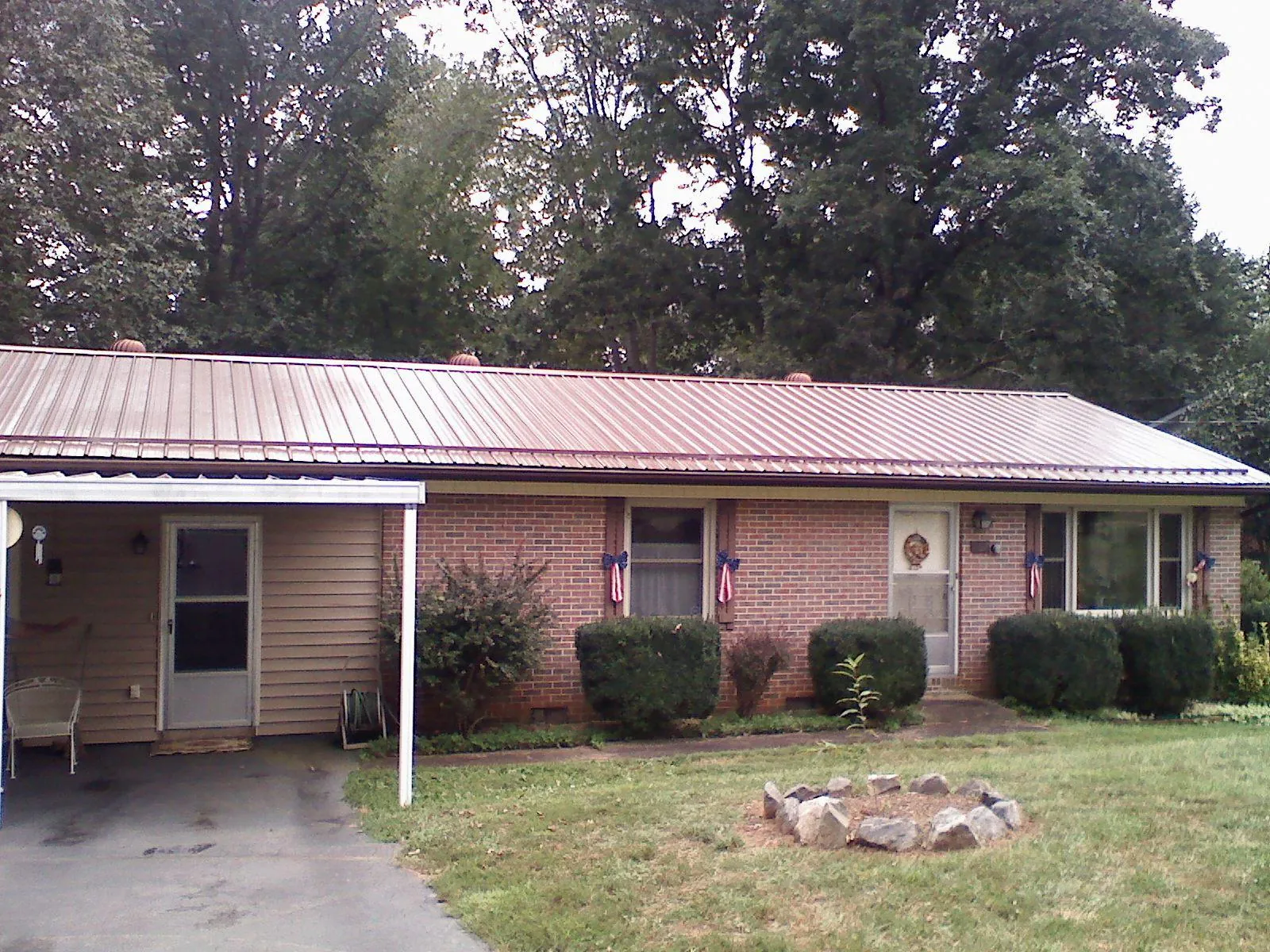 Bronze metal roof and carport on a brick ranch home — Roof Repair work by our crew in Clear Brook